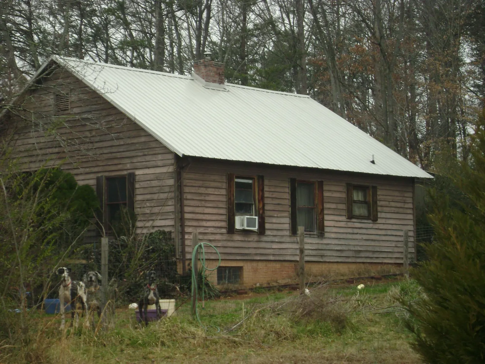 White metal roof on an old wood sided farmhouse, from a Asphalt Shingle Roof Repair job in Baltimore